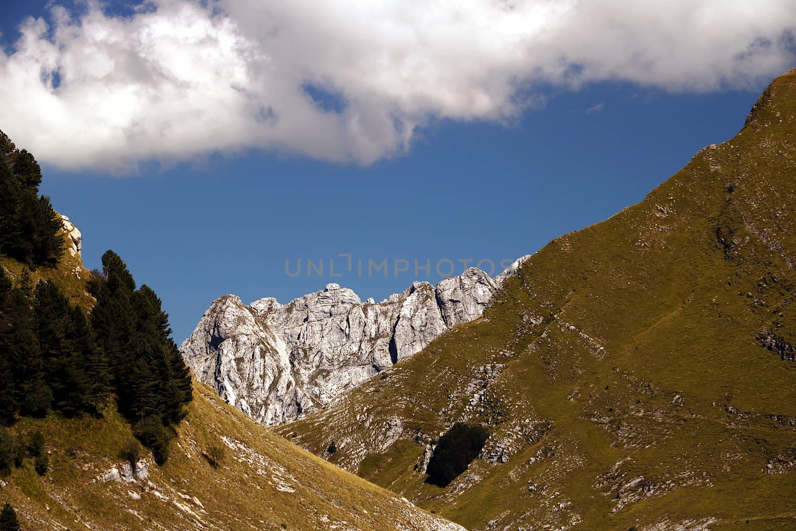 A landscape with Mount Sagro (right side) with clear skies and clouds. (Carrara, Toscana, Italy)