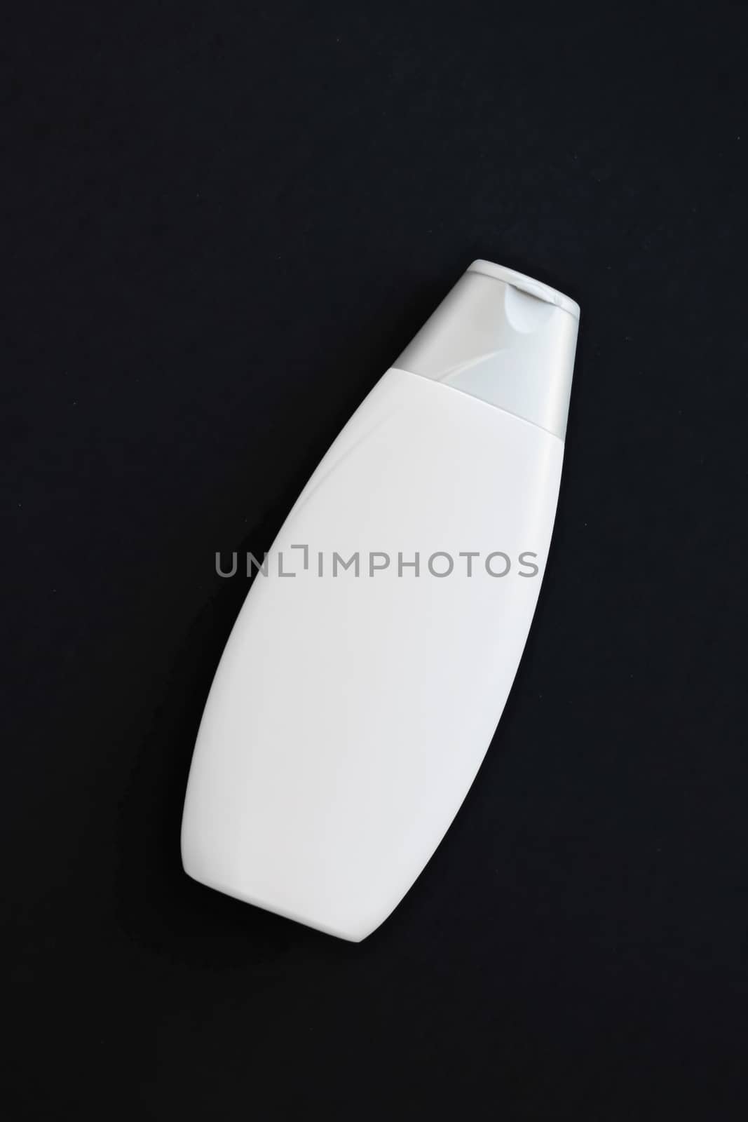Blank label cosmetic container bottle as product mockup on black background by Anneleven