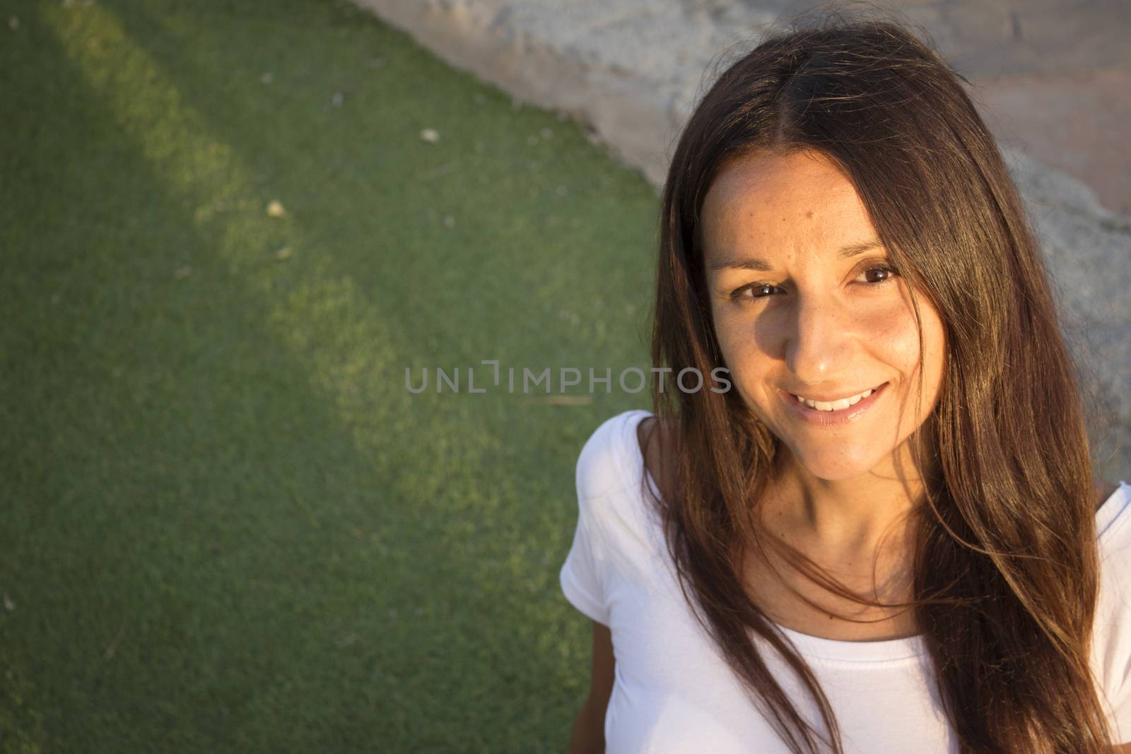 Portrait of young woman with happy expression. Green background