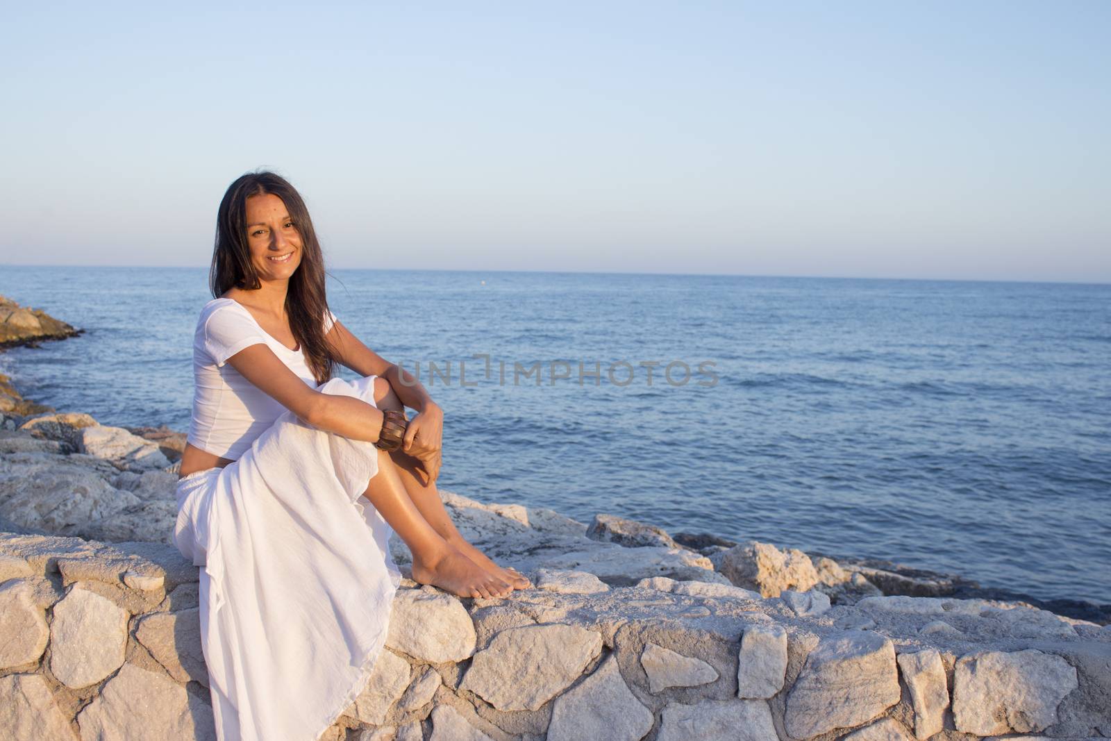 Woman in white dress on the beach by GemaIbarra