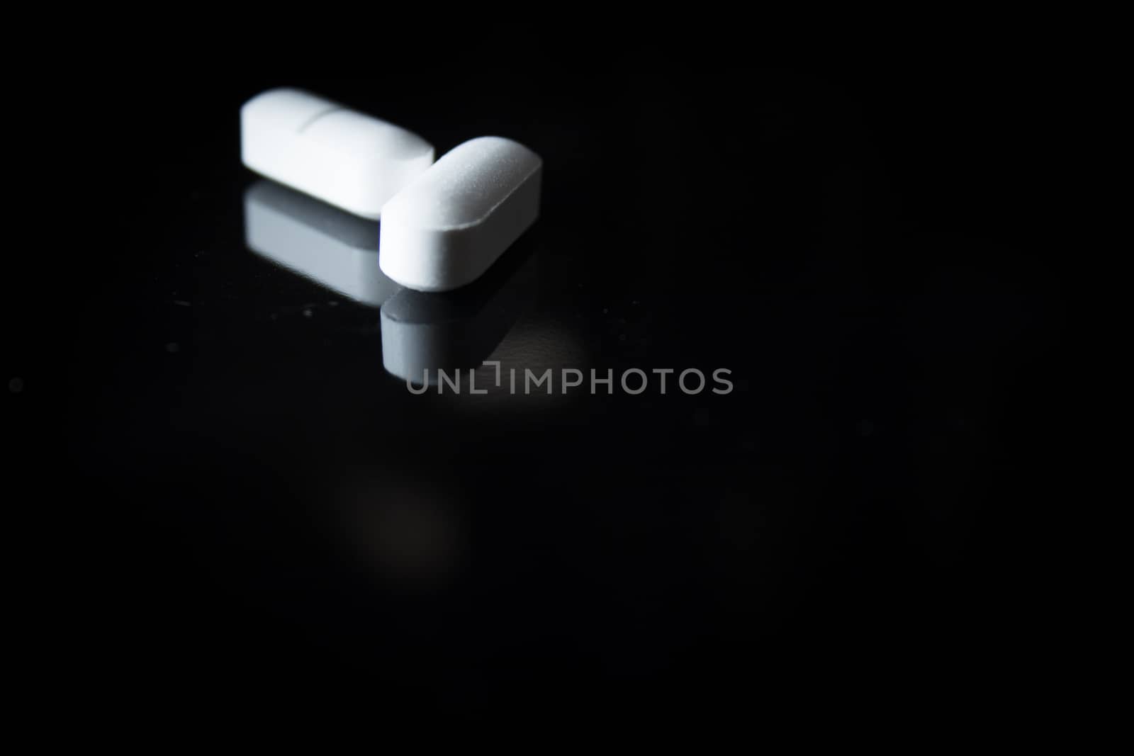 Woman holding generic white medicine pills