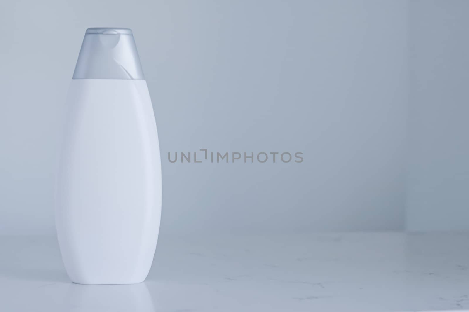 Blank label cosmetic container bottle as product mockup on gray background, hygiene and healthcare