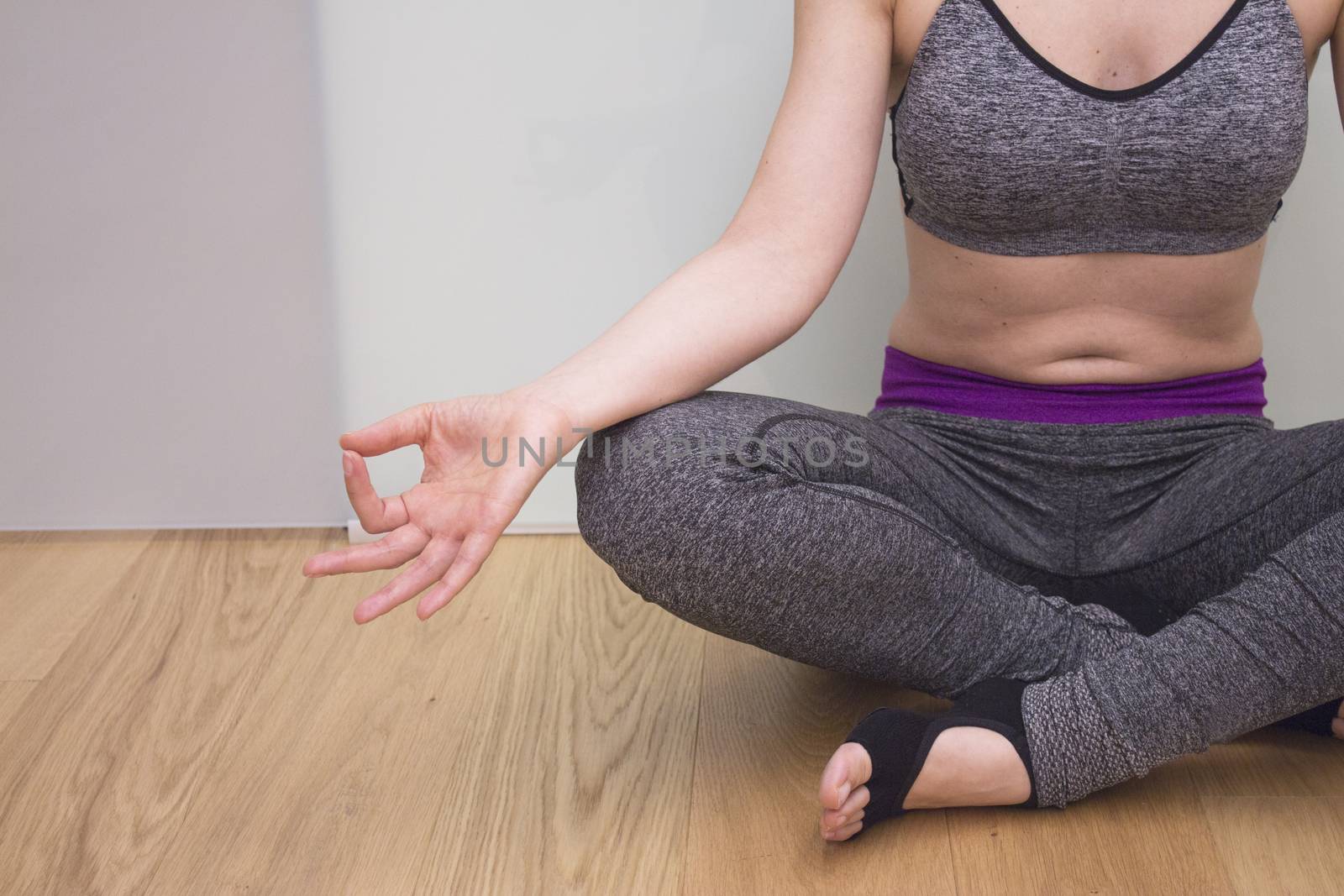 Womans hands practicing yoga and meditation positions by GemaIbarra