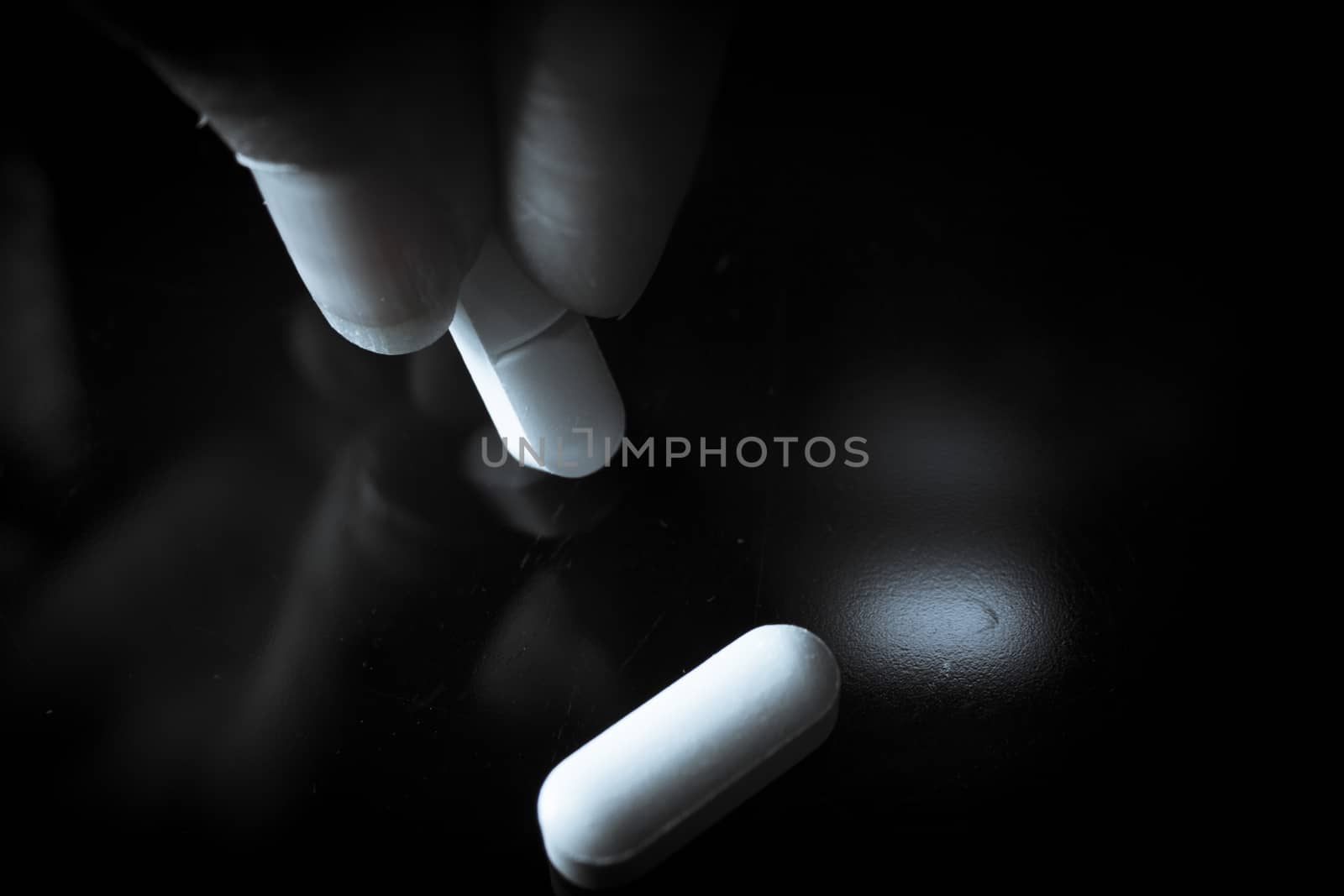 Woman holding generic white medicine pills