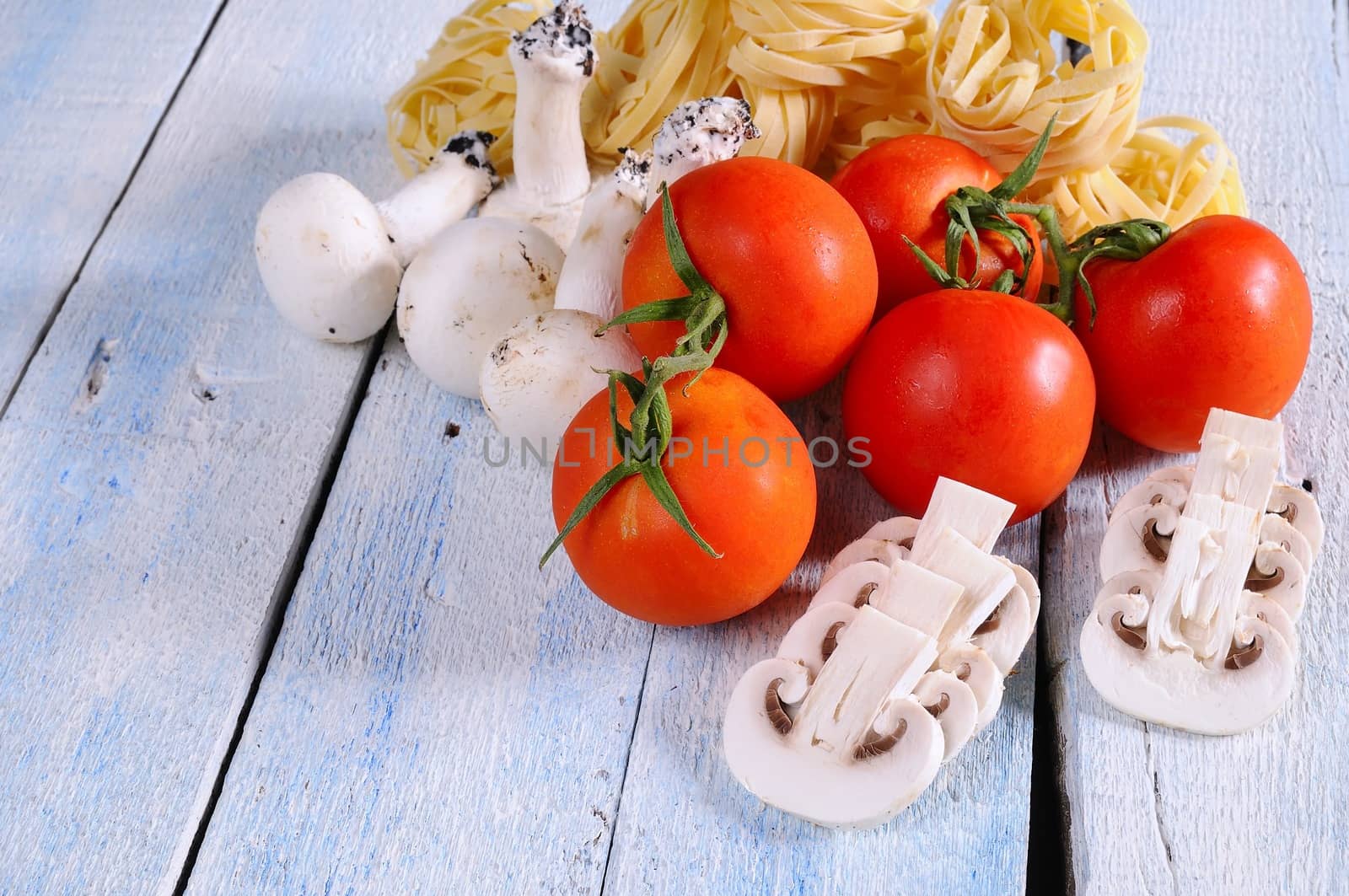 Tomato,mushrooms and tagliatelle over the kitchen table.