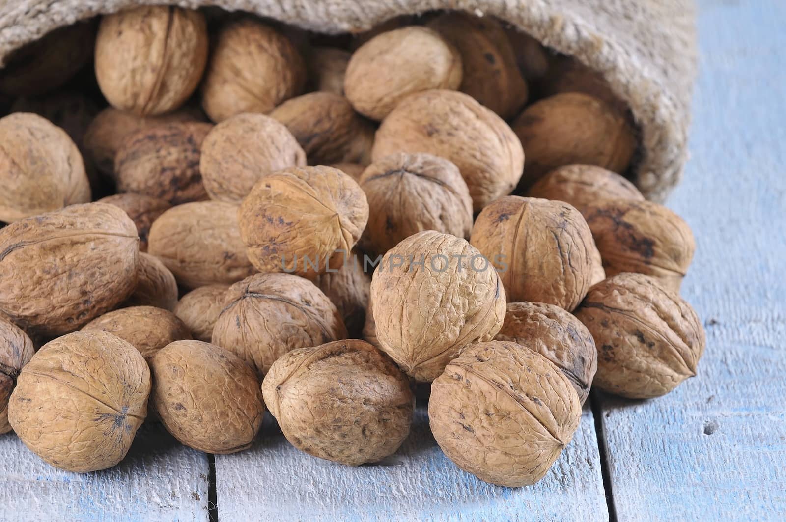 Walnuts on wooden table in the kitchen.