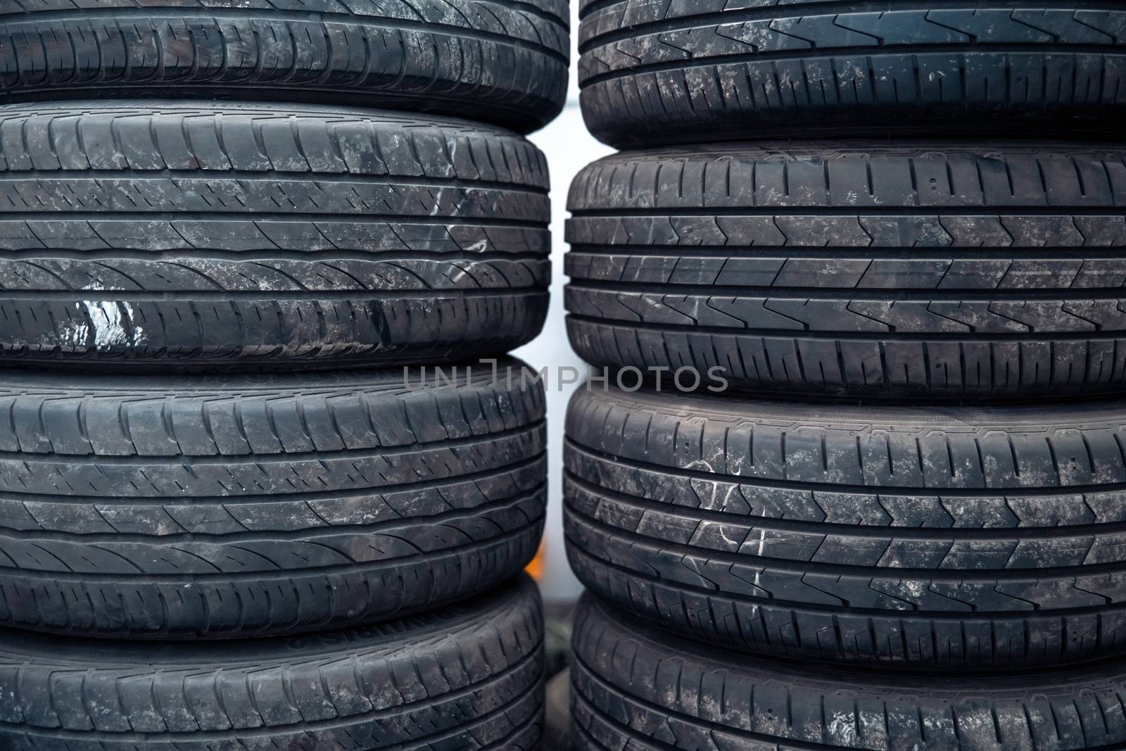 Tire sets in a car repair shop ready for a seasonal change on cars
