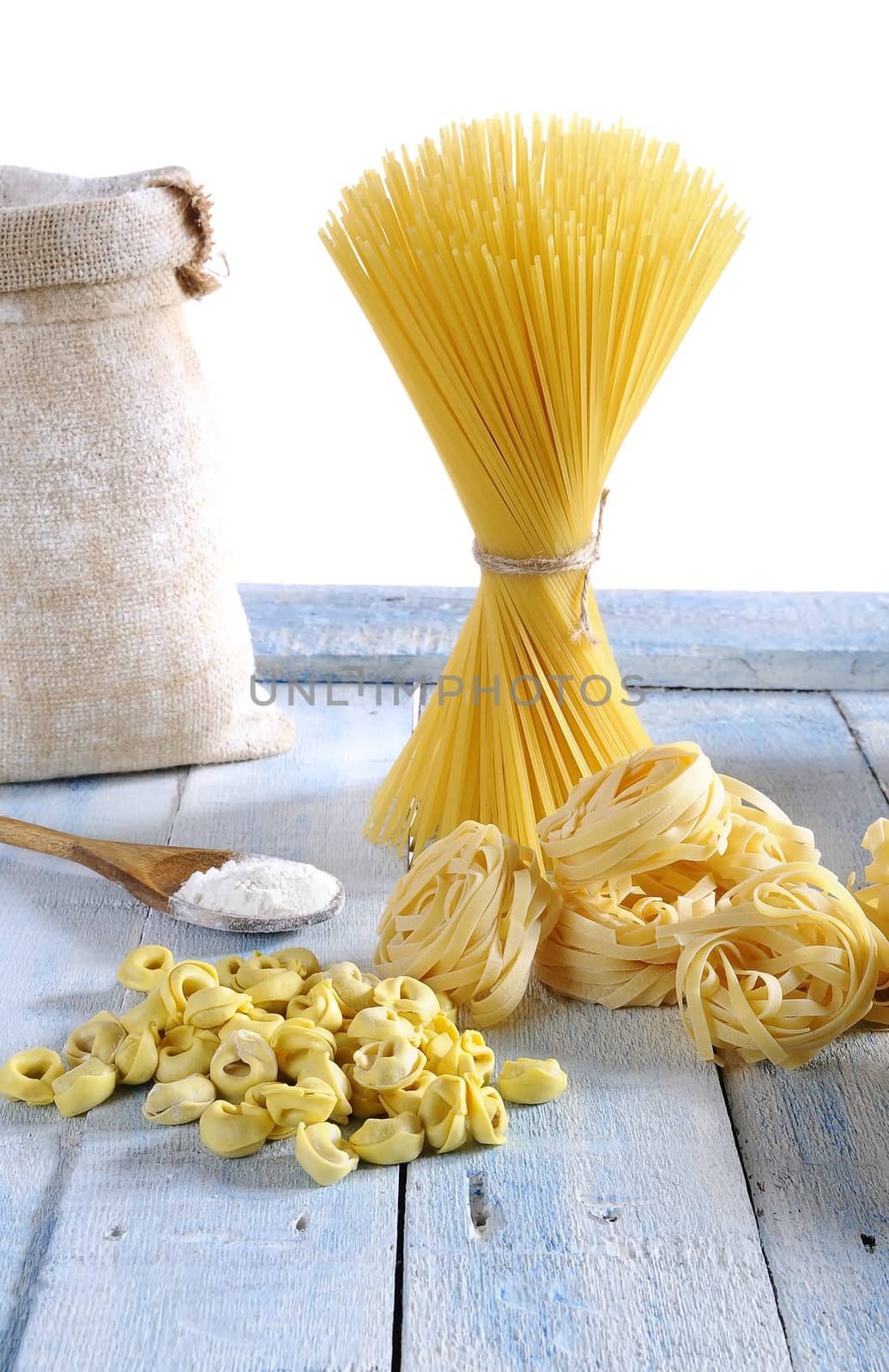 Pasta in a wooden table of kitchen.