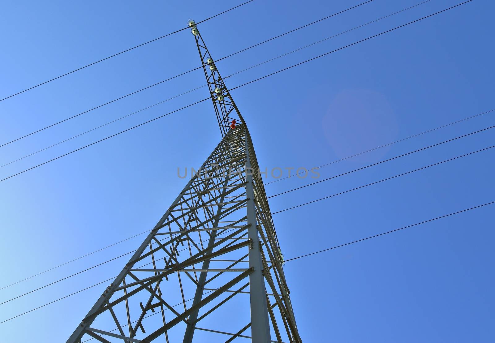 Close up view on a big power pylon transporting electricity in a countryside area in Europe