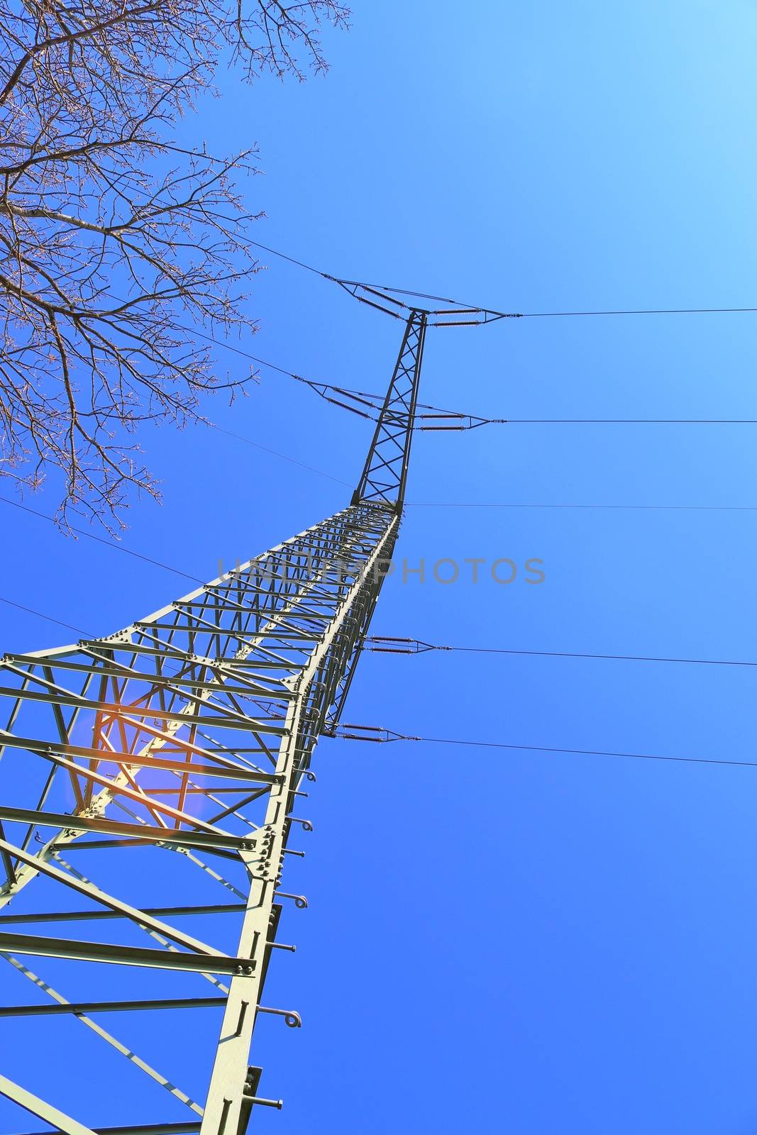 Close up view on a big power pylon transporting electricity in a by MP_foto71