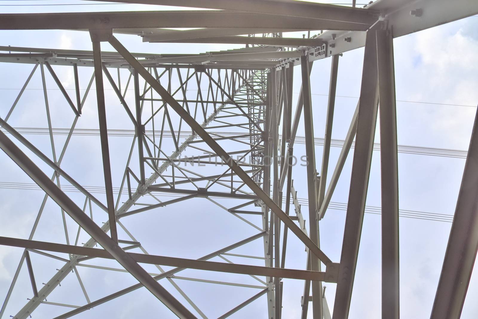 Close up view on a big power pylon transporting electricity in a countryside area in Europe