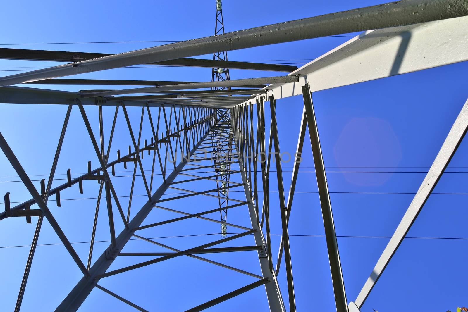 Close up view on a big power pylon transporting electricity in a countryside area in Europe