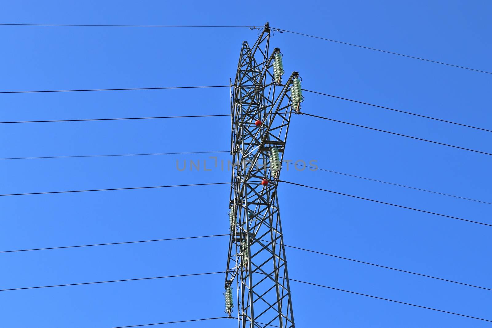 Close up view on a big power pylon transporting electricity in a countryside area in Europe