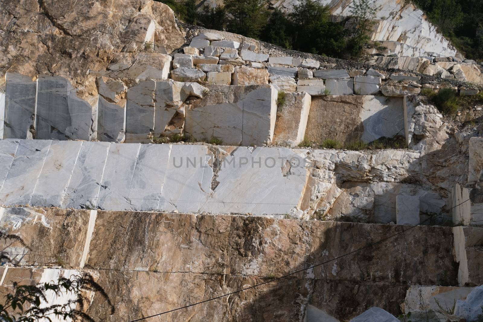 White Carrara marble quarry in the Apuan Alps in Tuscany. Mountain walls cut with diamond wire.