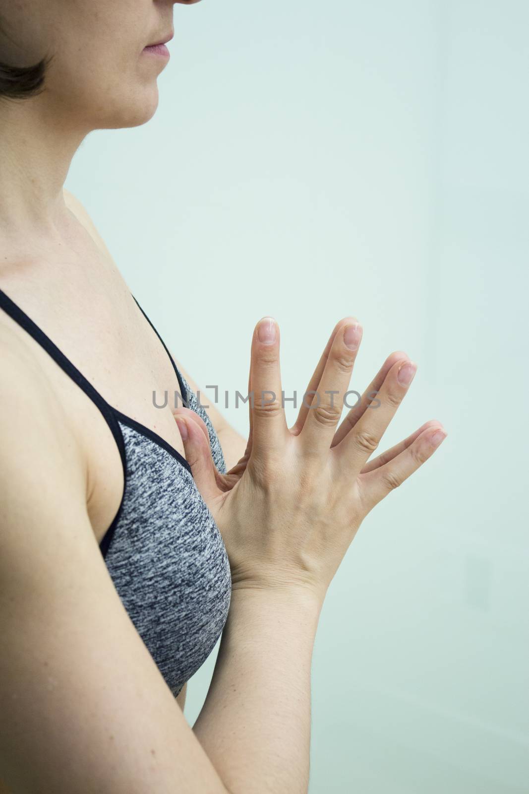 Womans hands practicing yoga and meditation positions by GemaIbarra