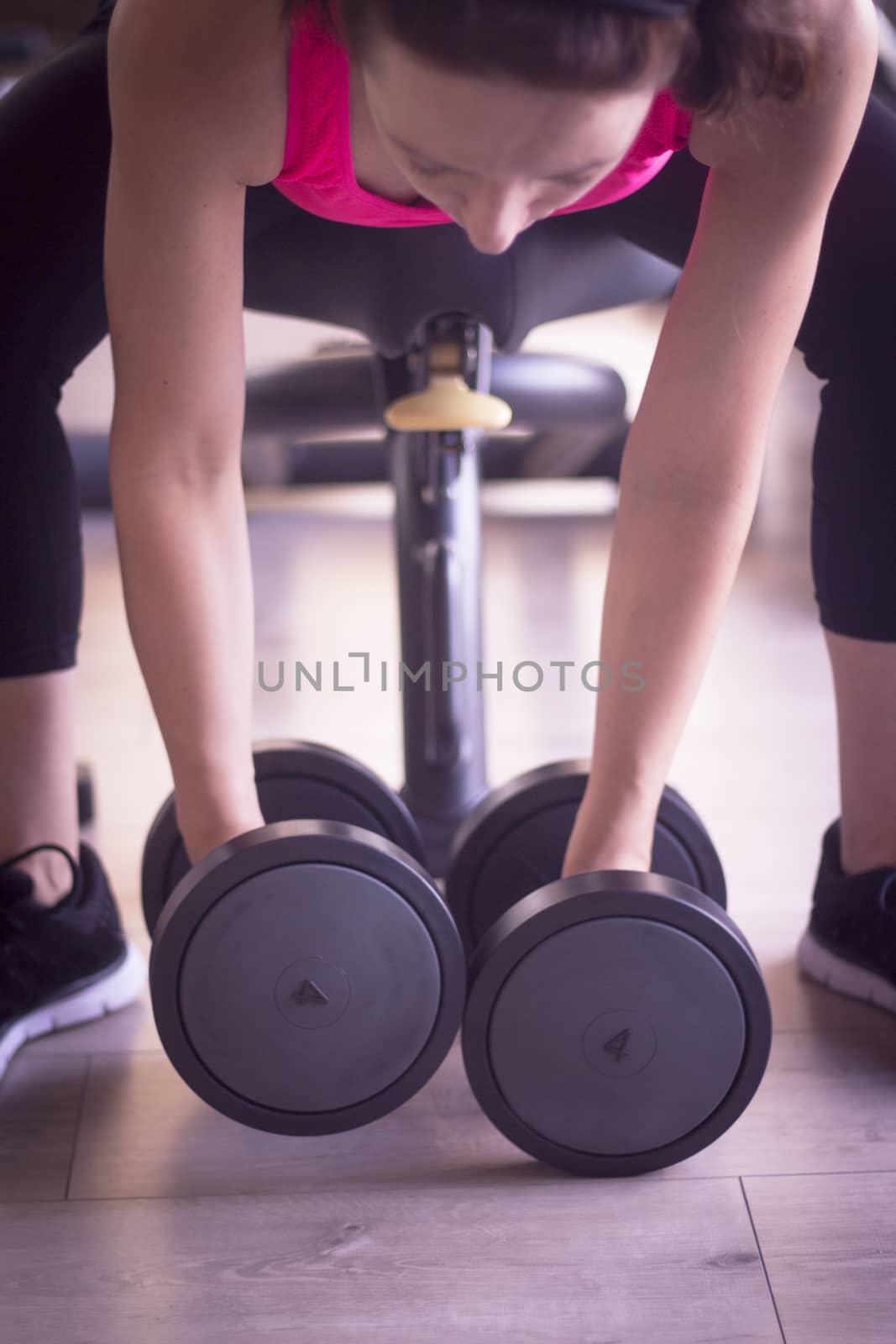 Woman doing dumbbells at happy gym