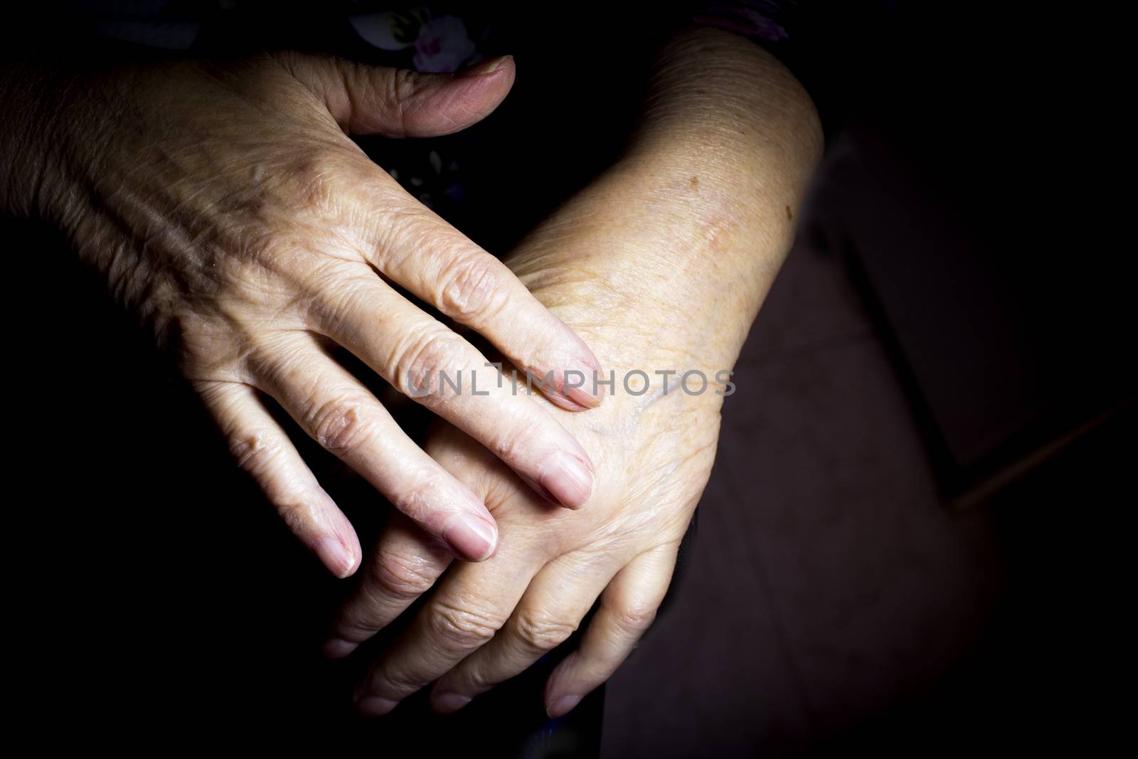 Hands of elderly woman doing a selfmassage. Manual physiotherapy 