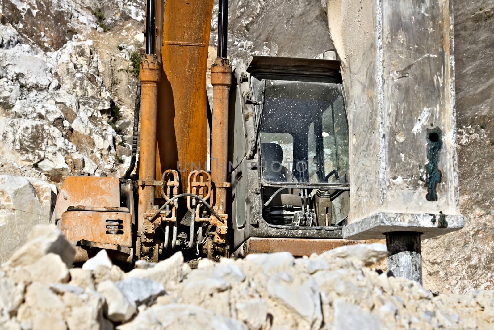 Excavator with demolition hammer in a Carrara marble quarry. A l by Paolo_Grassi