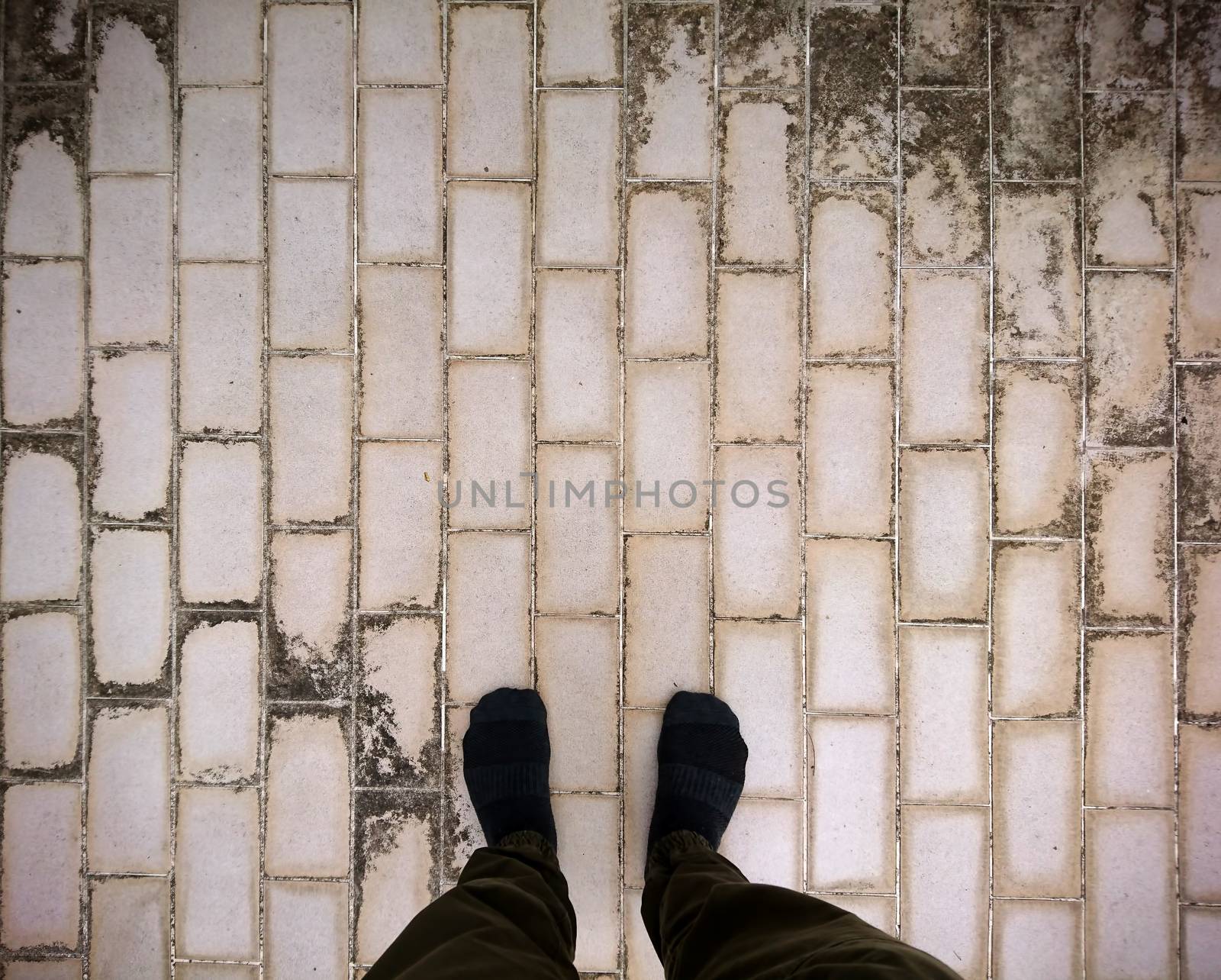 Foot wear sock standing on dirty ceramic tiles by liewluck