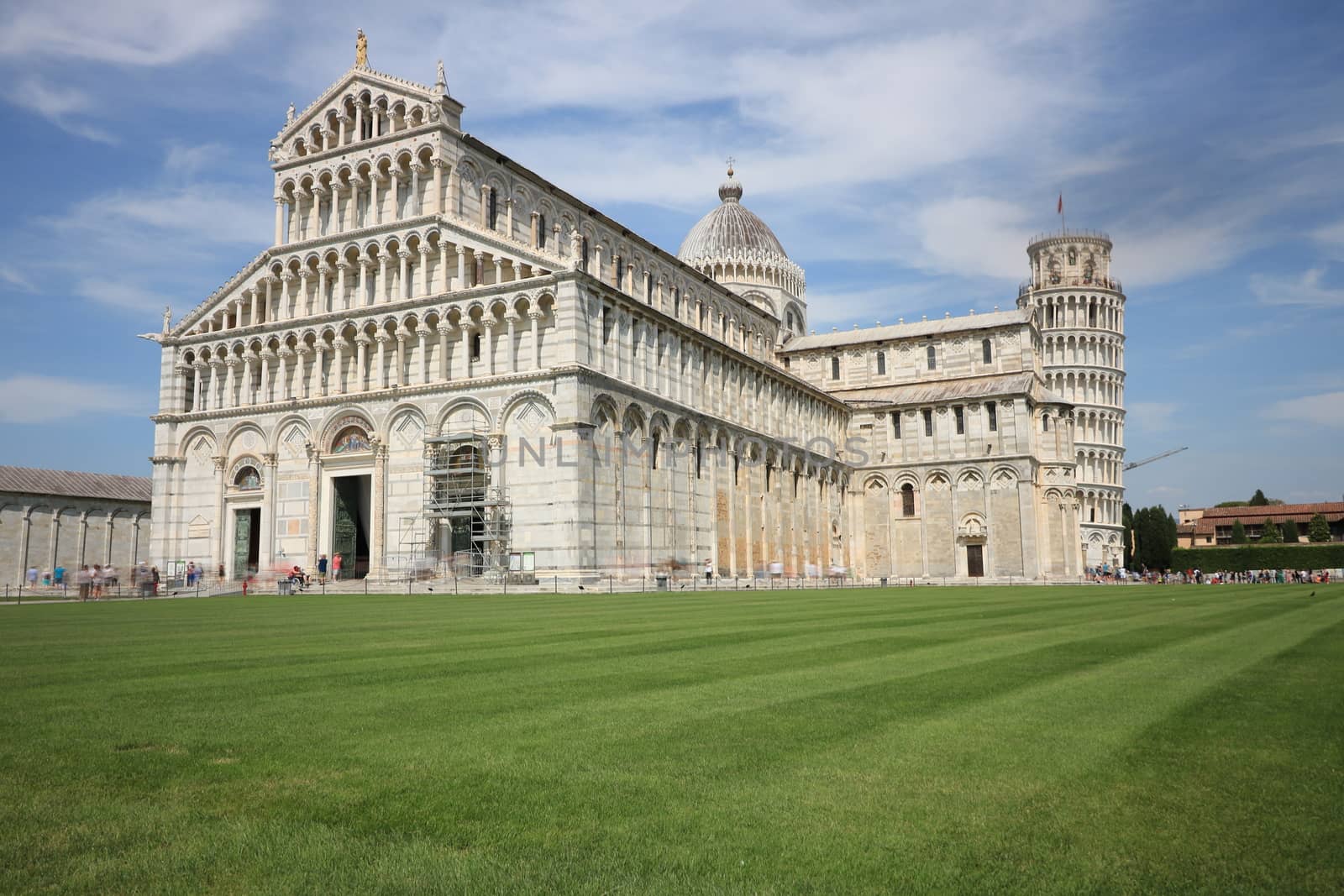 Pisa, Tuscany, Italy. 06/21/2019. Piazza dei miracoli of Pisa. Cathedral, leaning tower of the Tuscan city. Blue sky with clouds.