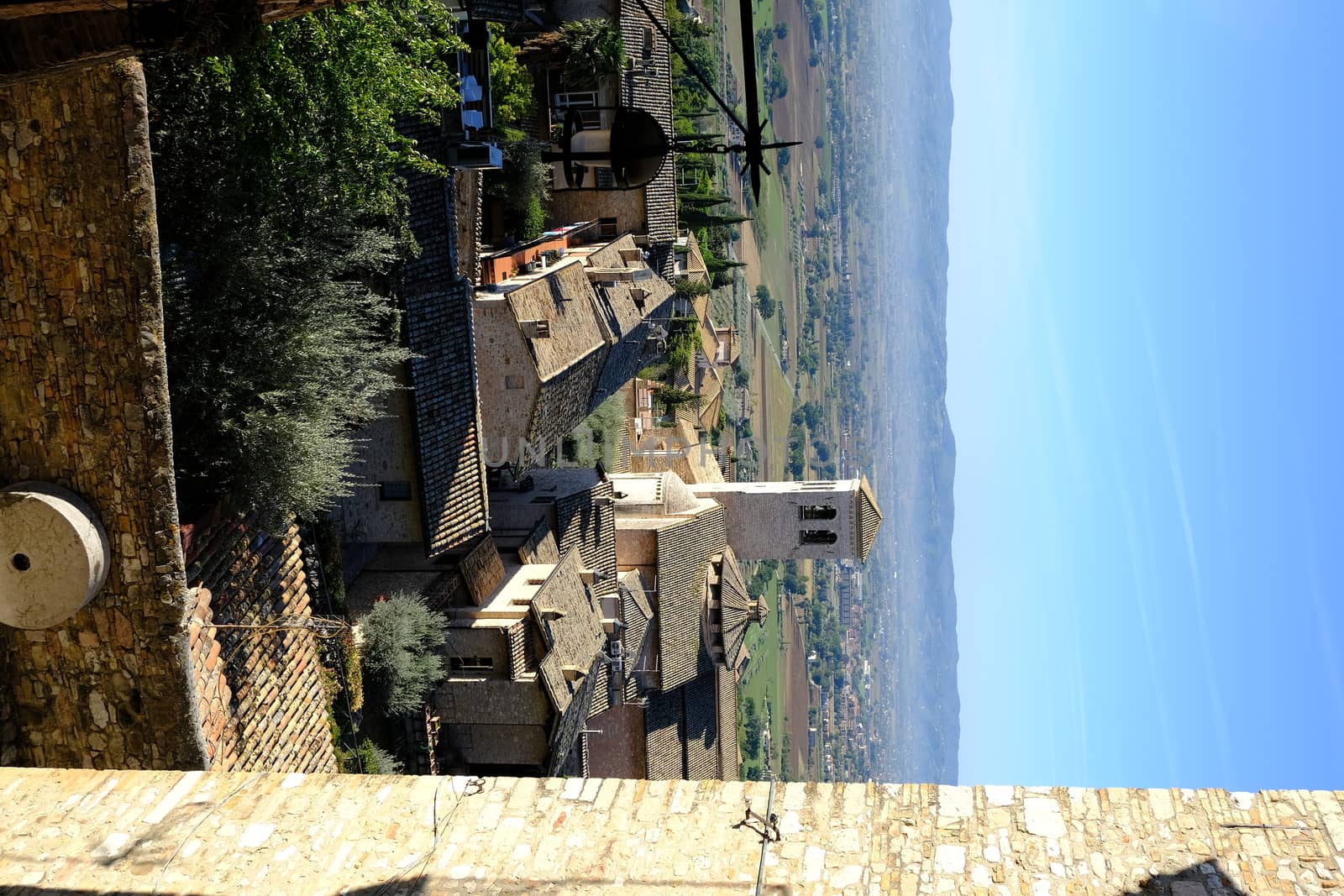 Panorama of the Assisi countryside with churches, houses and trees. From the top of the city you can enjoy a splendid panoramic view of the valley.