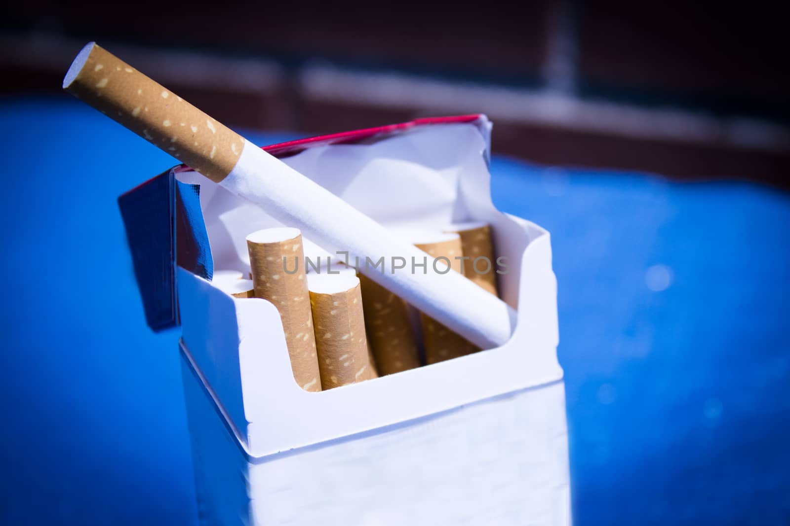 Open cigarette pack with cigarettes out. No people