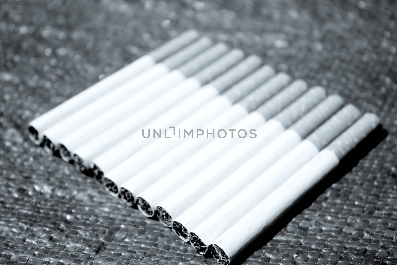 Row of cigarettes on table. No people