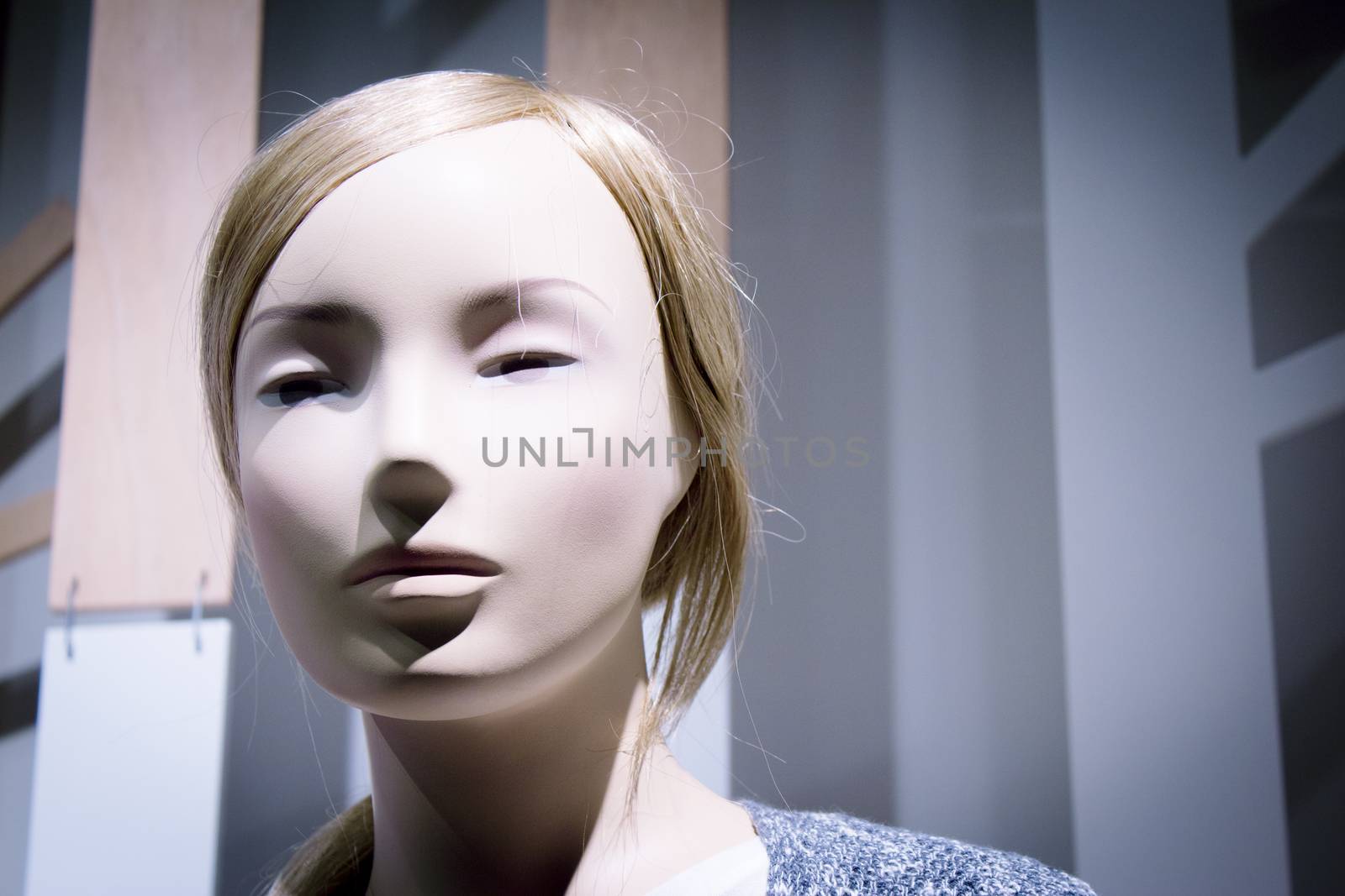 Young mannequin with short hair. Neutral expression. No people