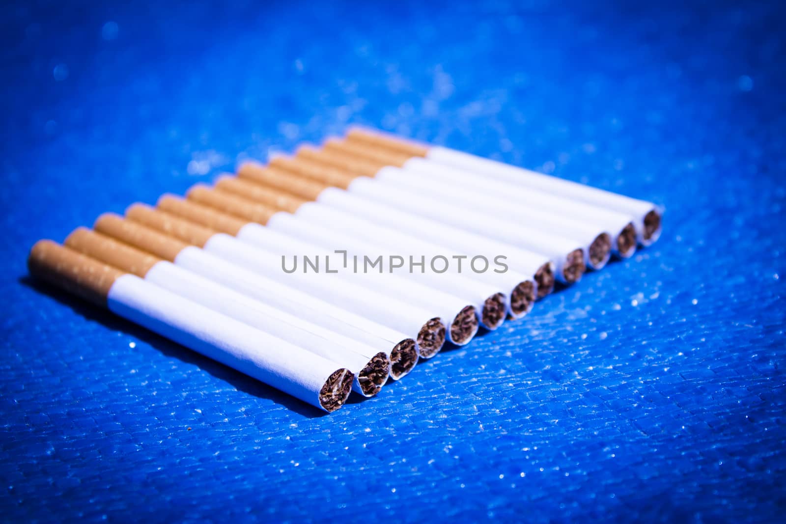 Row of cigarettes on table. No people