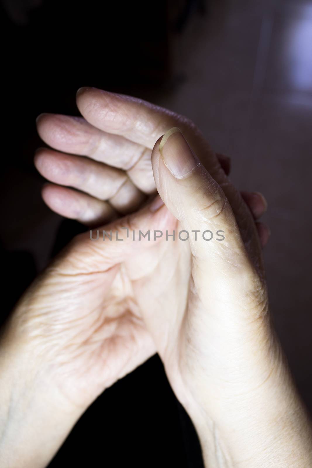 Hands of elderly woman doing a selfmassage. Manual physiotherapy 
