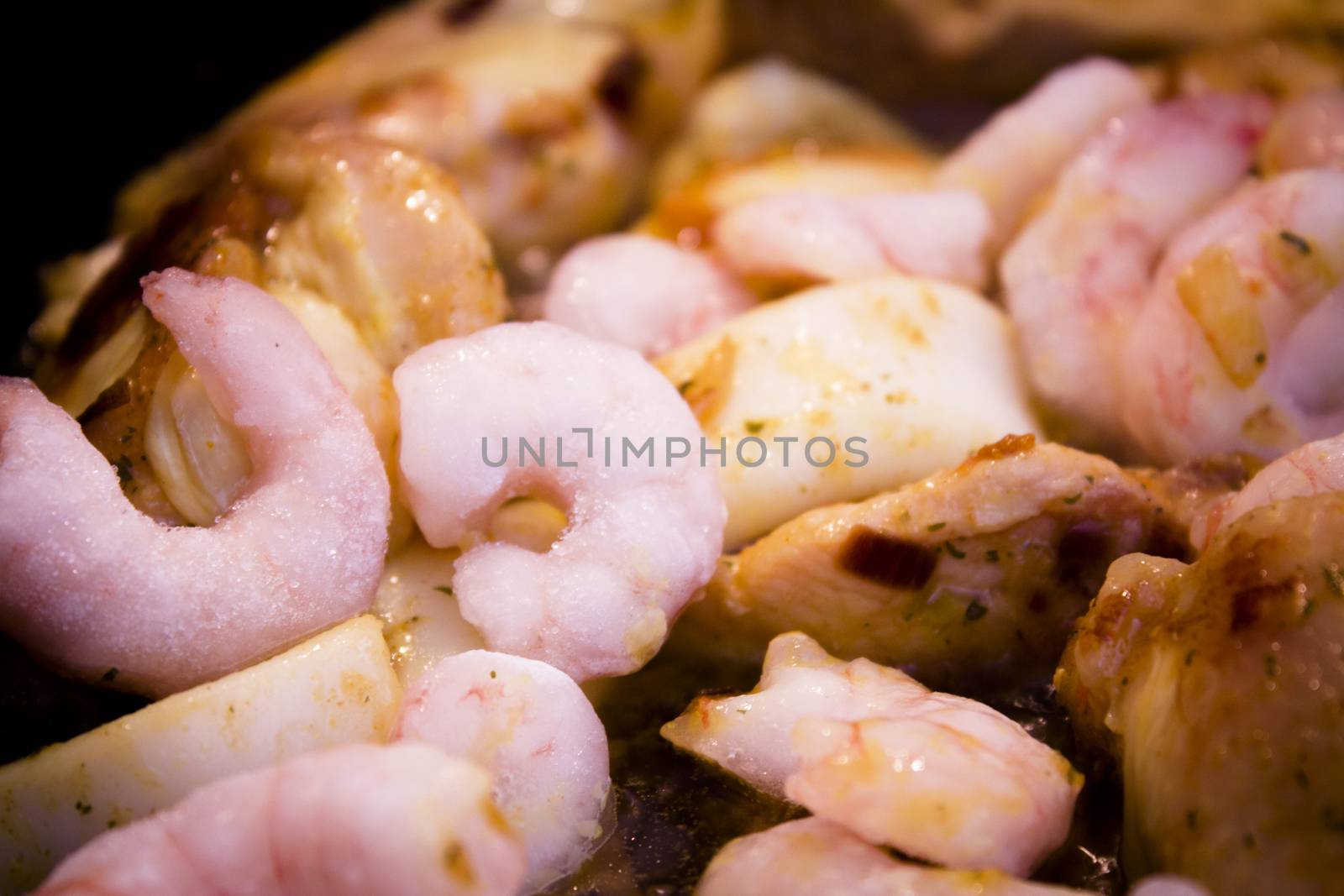Vegetable stir fry with seafood and chicken to prepare paella. No people