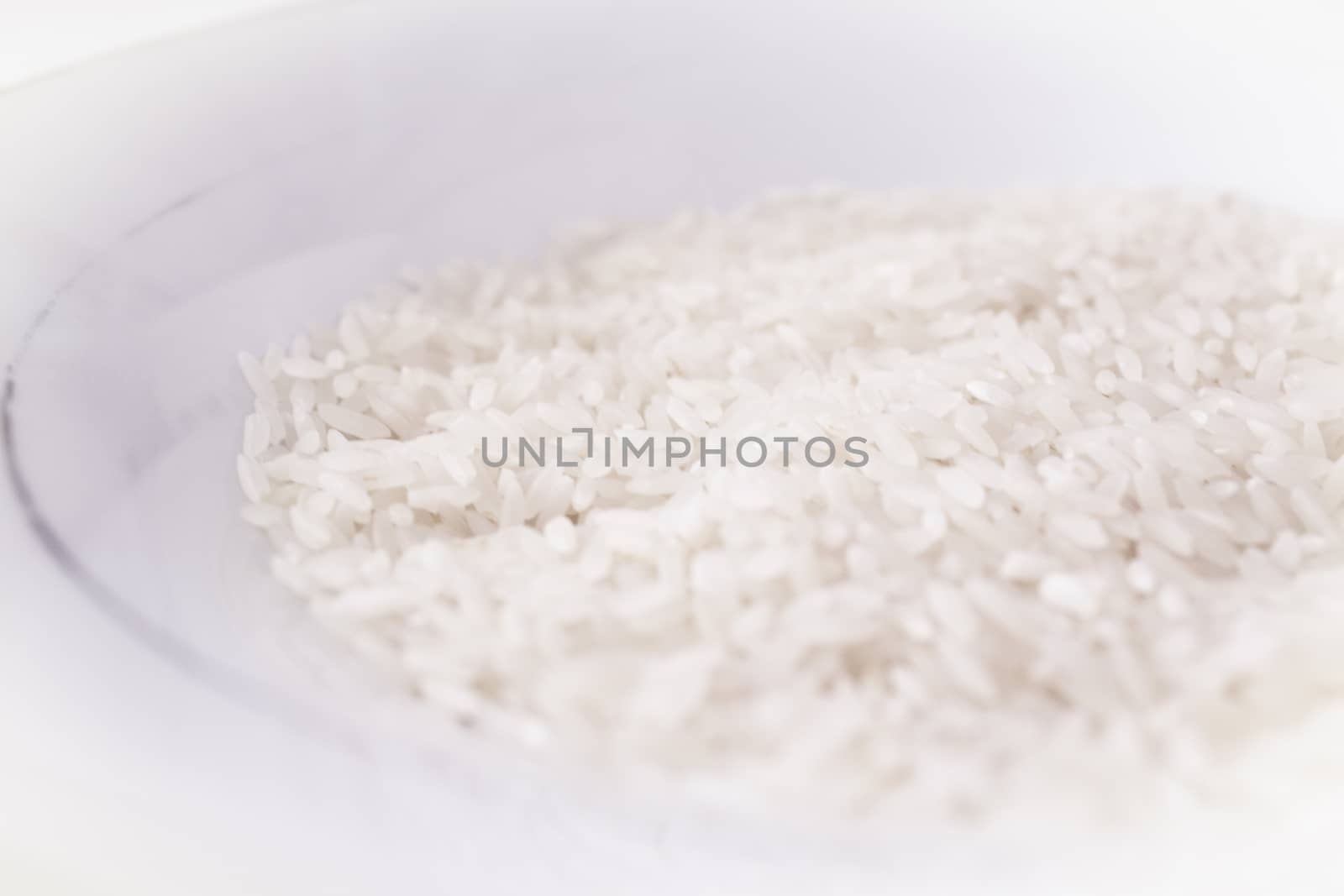 Uncooked white rice. Part of the rice out of focus. No people