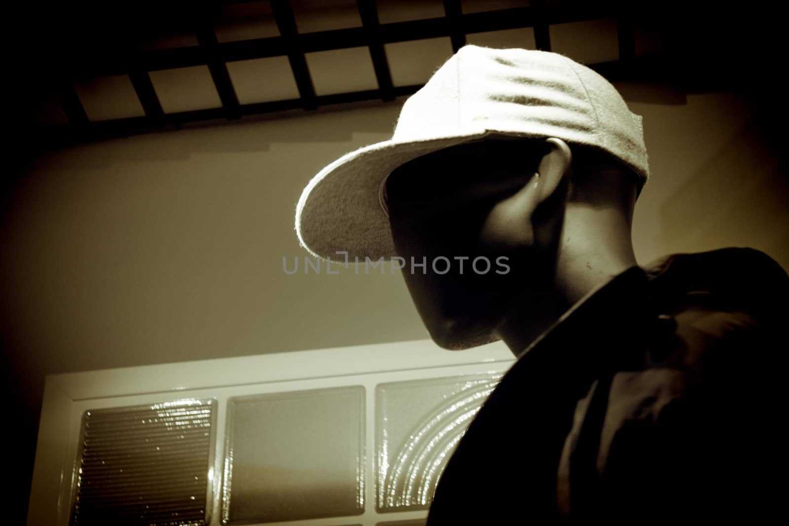 Black male mannequin without defined face with cap