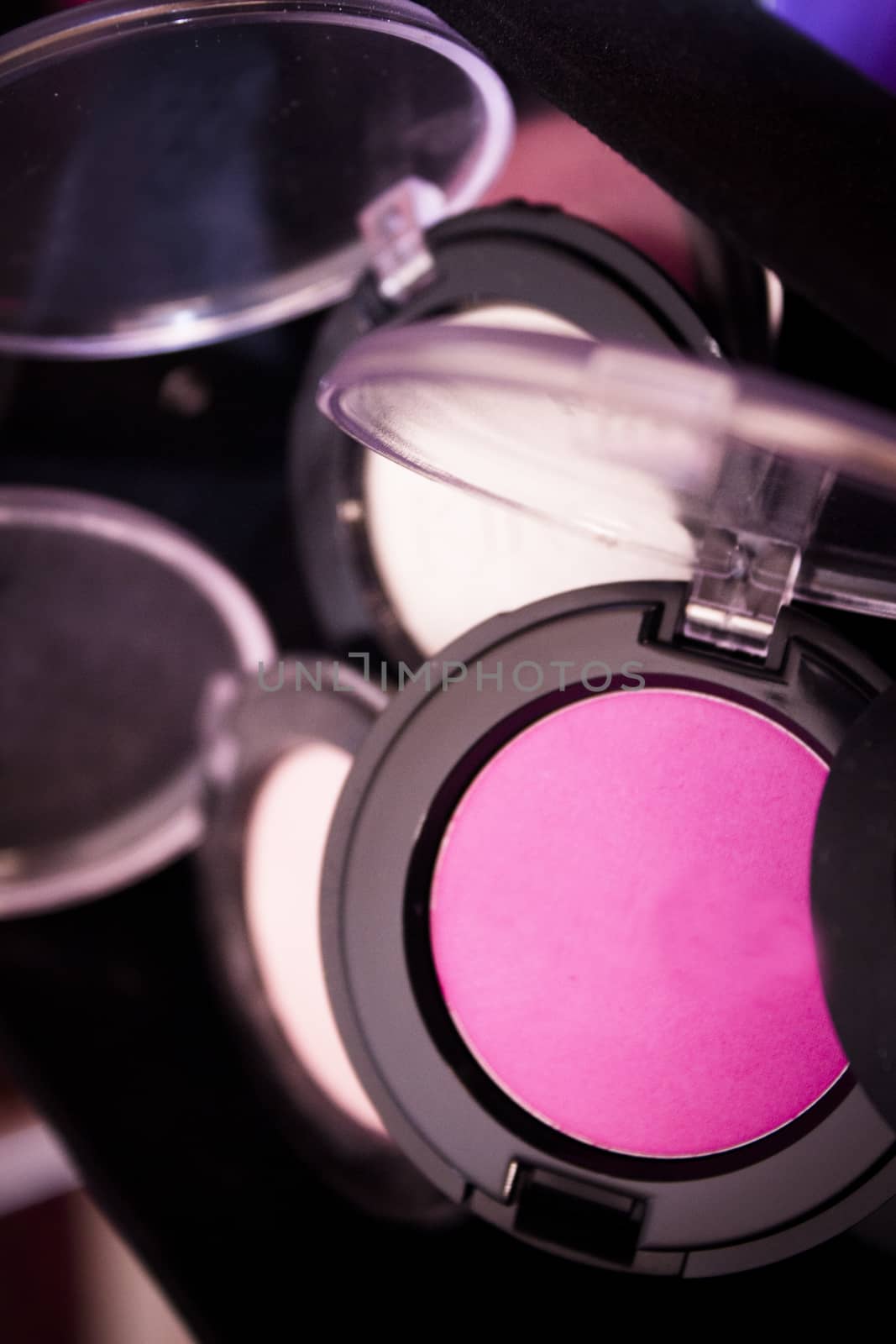 Various makeup shadows on dark background. No people