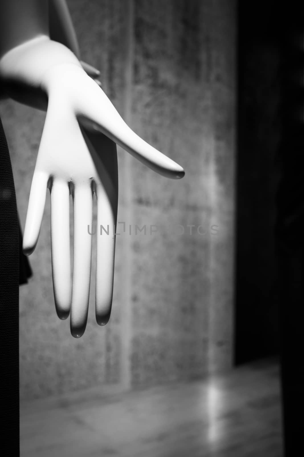 Artificial hand showing palm of hand on dark background. No people