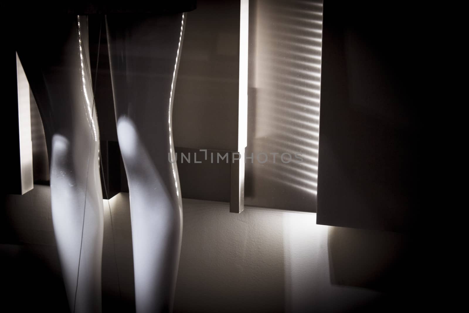 Female mannequin legs on dark background. No people