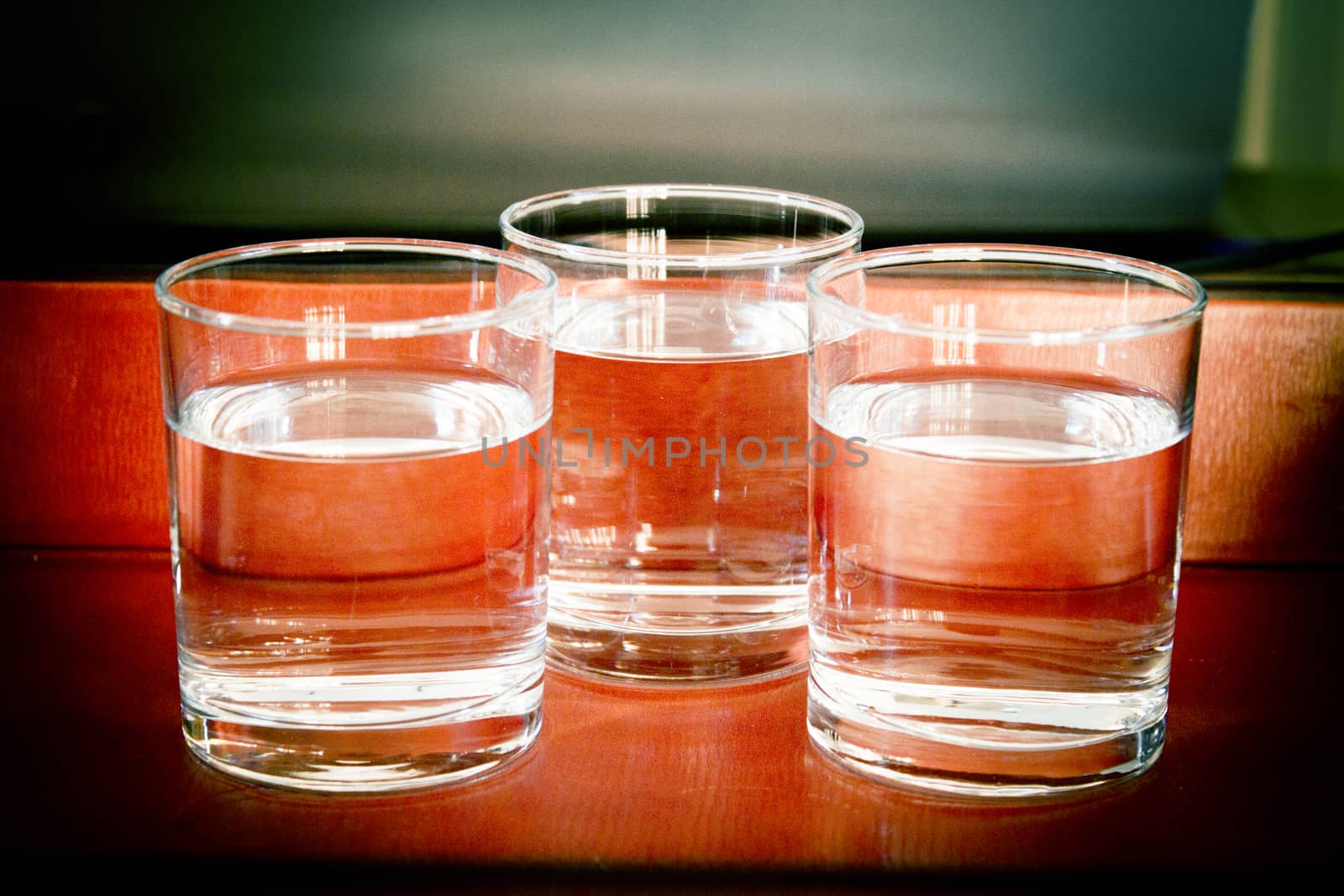 Glass glasses filled with water on a table. No people