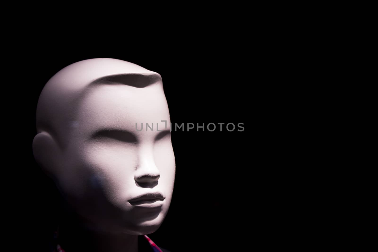 Child mannequin portrait on dark background without expression. No people