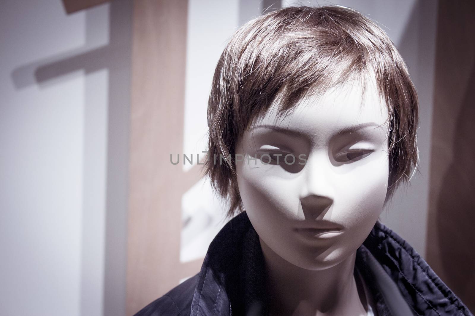 Young mannequin with short hair. Neutral expression. No people