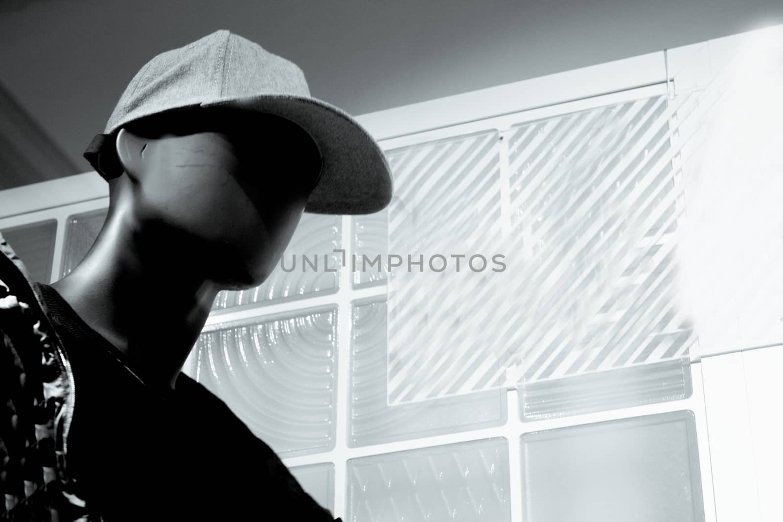 Black male mannequin without defined face with cap