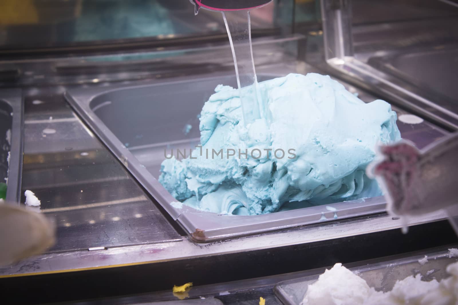 Artisan ice cream in a metal container to keep the cold. No people