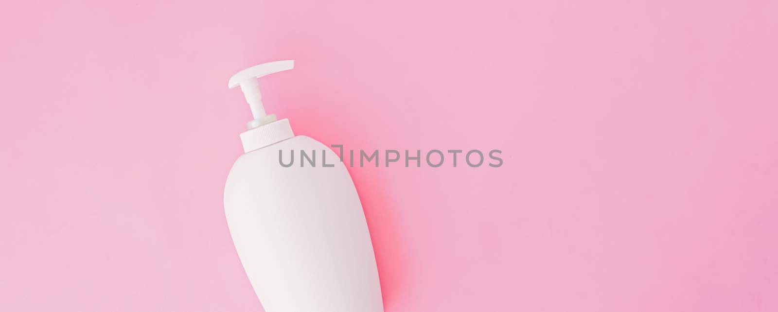 Bottle of antibacterial liquid soap and hand sanitizer on pink background, hygiene product and healthcare, flatlay