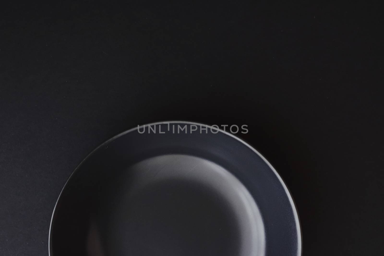 Empty plates on black background, premium dishware for holiday dinner, minimalistic design and diet concept