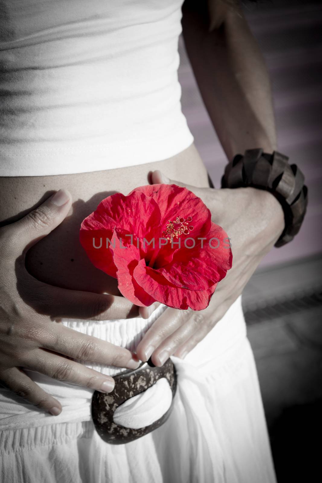 Flat belly of woman with red flower, health symptom