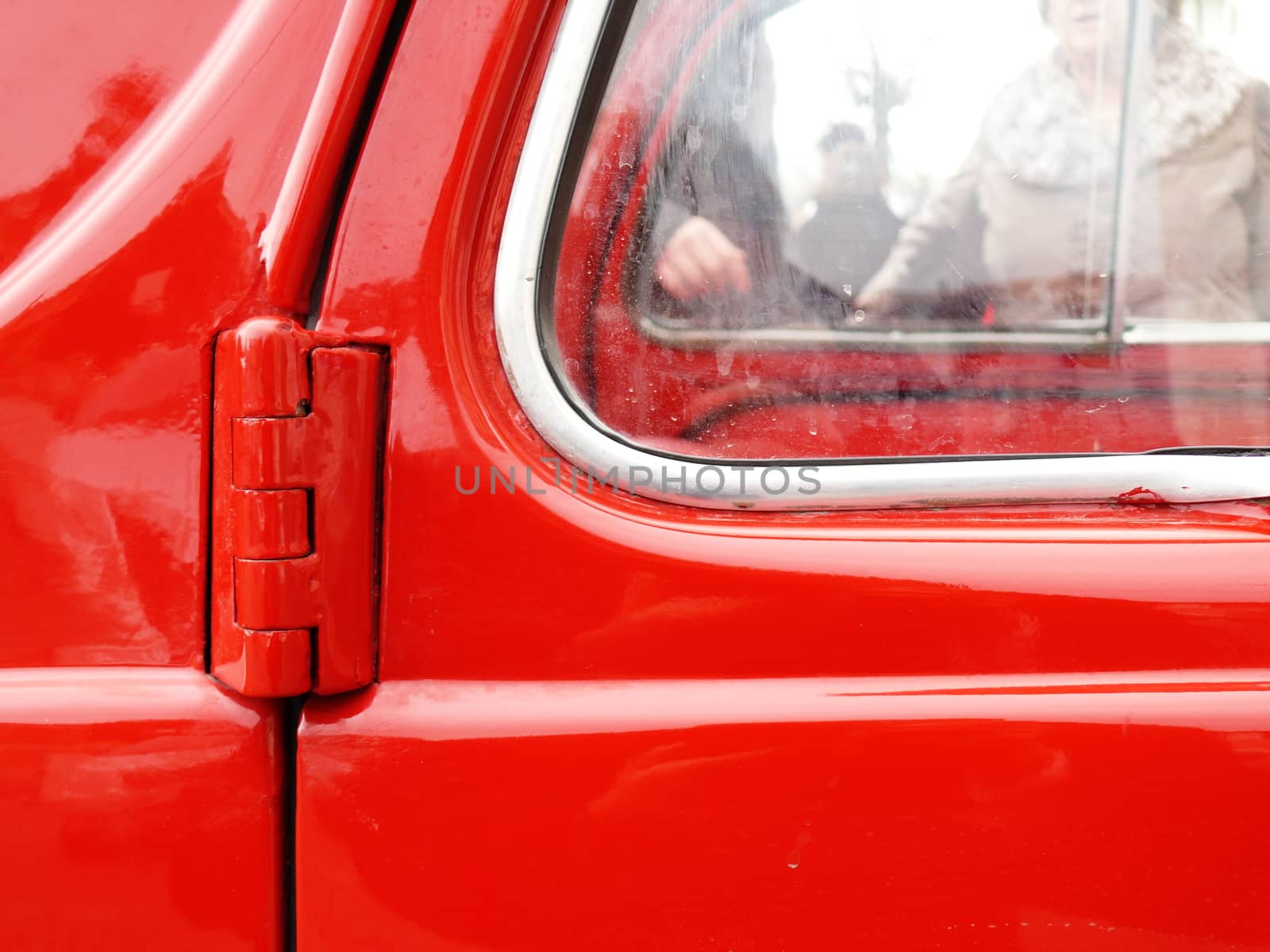 Old car painted in bright red with chrome details