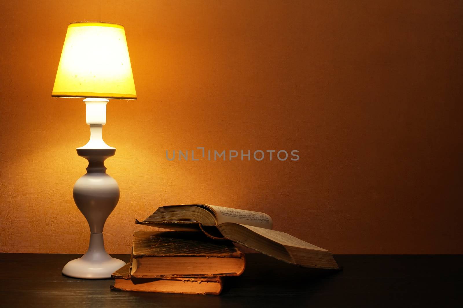 Elegance white desk lamp with yellow lampshade near open book