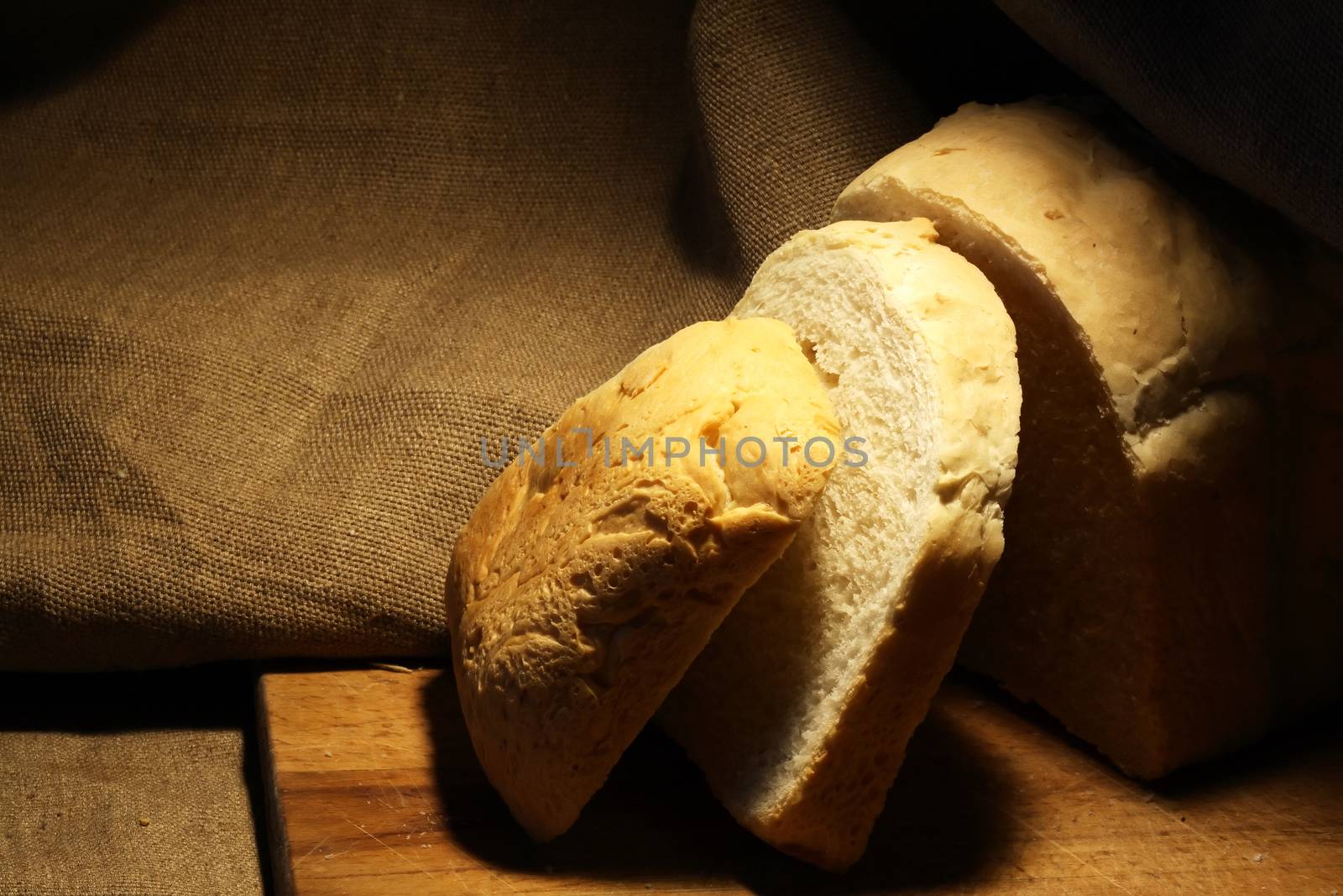 Sliced loaf of white bread on canvas background