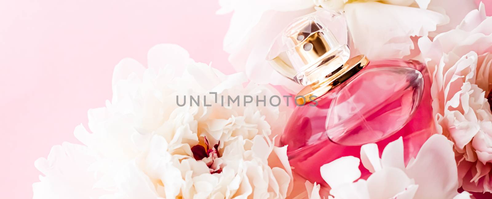 Luxurious fragrance bottle as chic perfume product on background of peony flowers, parfum ad and beauty branding design