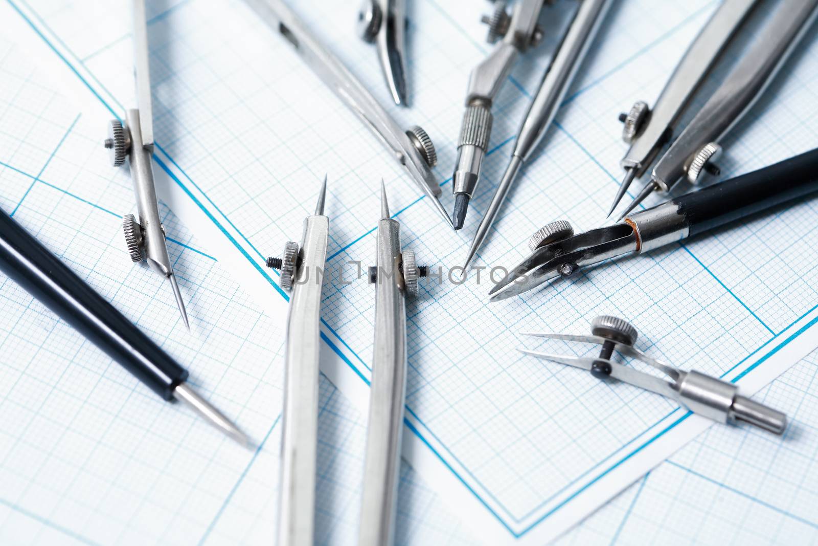 Set of old drawing tools on background with graph paper