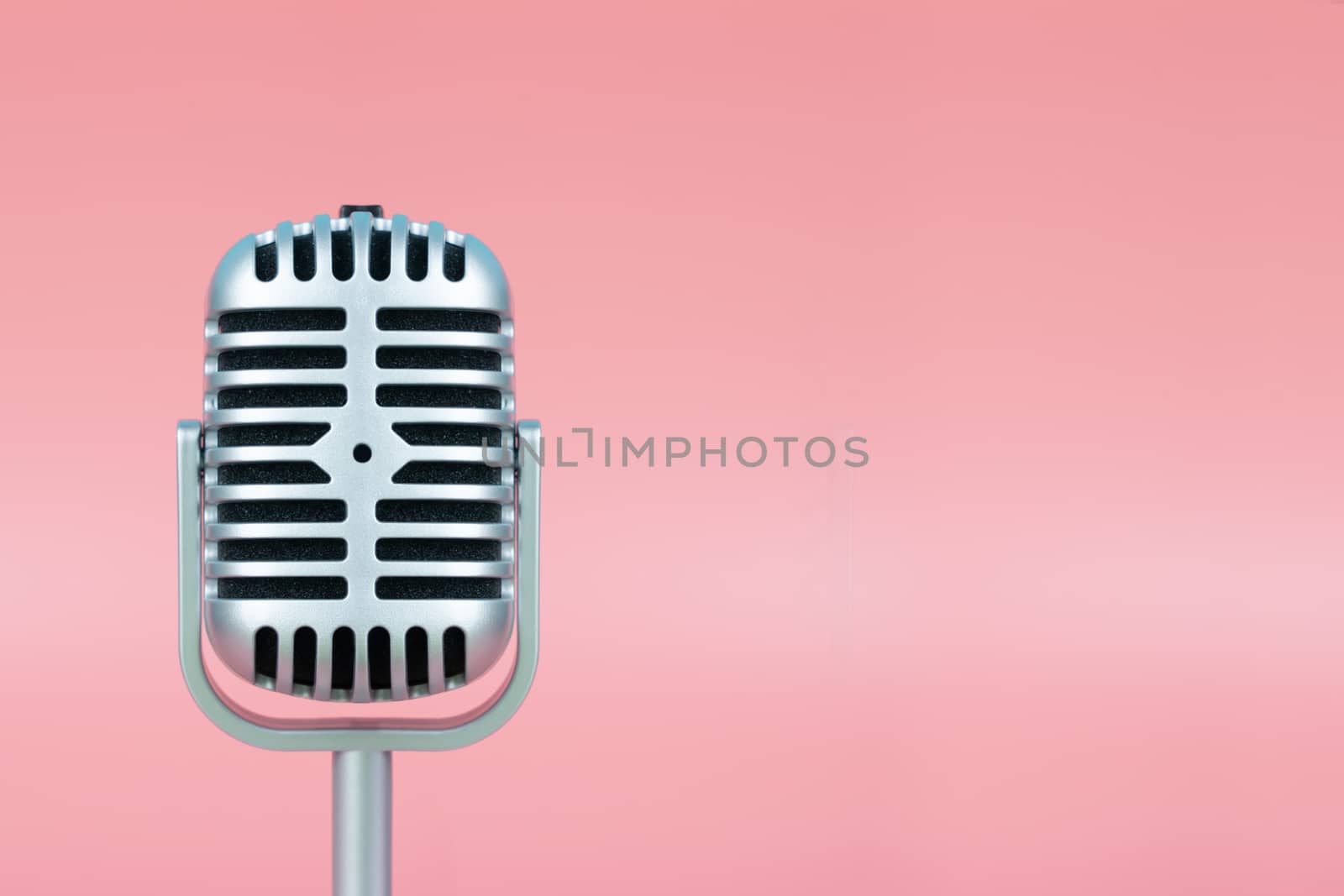 Retro microphone with copy space on pink background